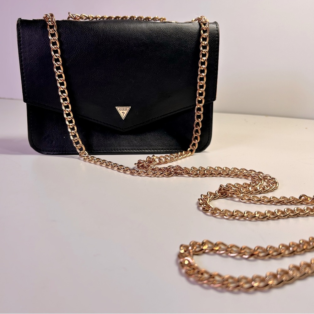 Guess Flap over handbag crossbody shoulder bag, black with gold chain strap.